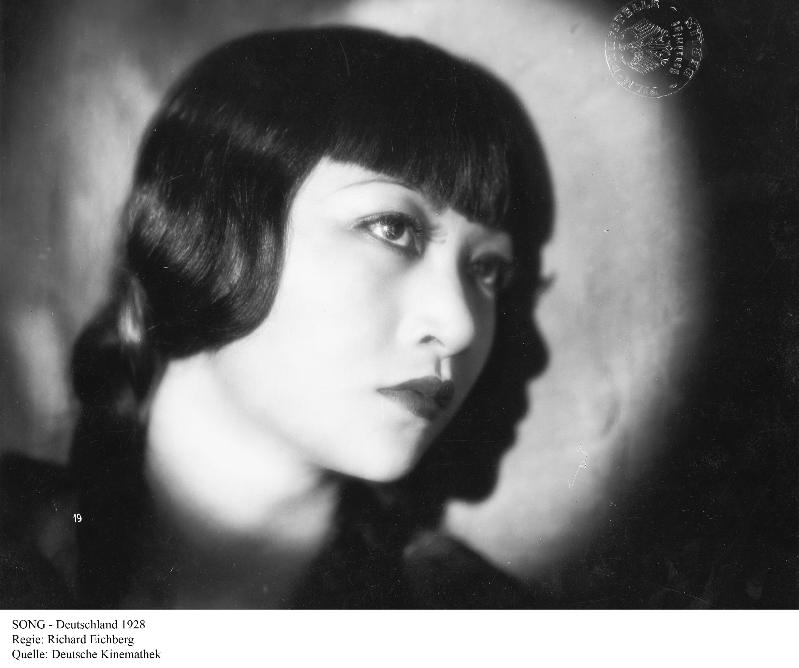A film clip from the movie "Song." The profile of Anna May Wong is captured.